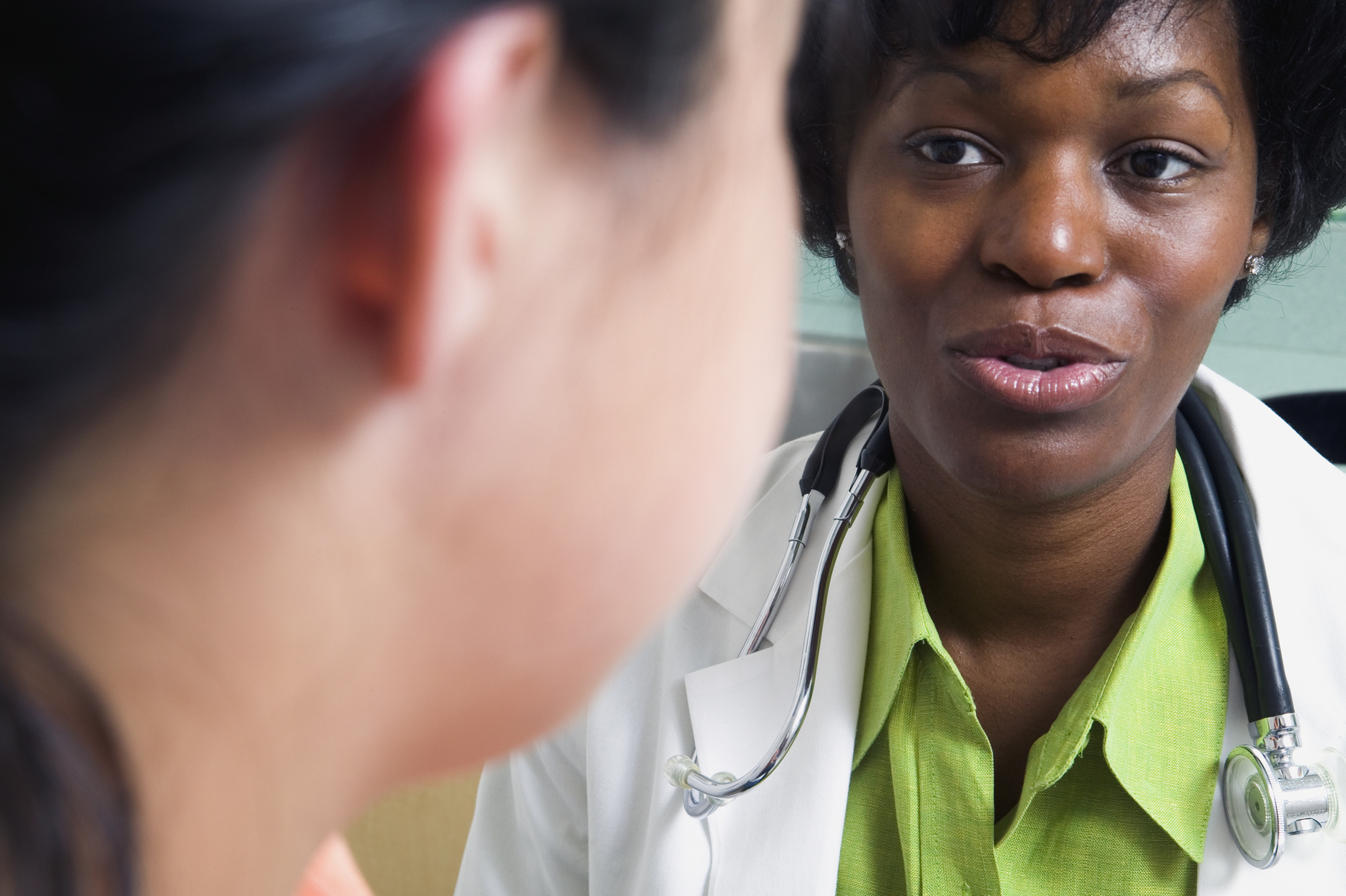 Photo: close up of doctor talking to patient